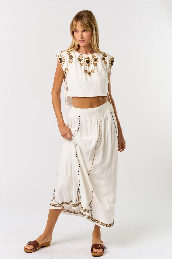 Boho-inspired women's boutique clothing with embroidered crop top and matching maxi skirt for summer collection.
