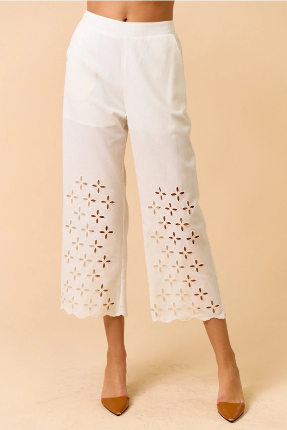 White scalloped pants for women featuring embroidered cutouts and pockets, perfect for summer casual wear. Women's boutique clothing.