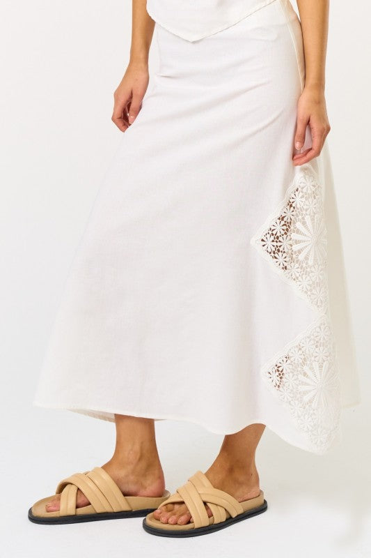 White maxi skirt with embroidered patches, ideal for women's boutique clothing and summer collection styles.
