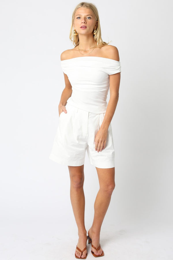 Model in elegant off-the-shoulder knit top, showcasing women's boutique clothing for summer collection and exclusive women's fashion.