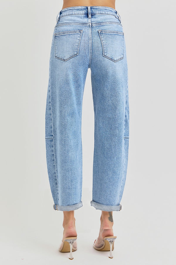 Back view of women's high rise barrel jeans with cuff hem in light blue denim, perfect for boutique summer collection outfits.