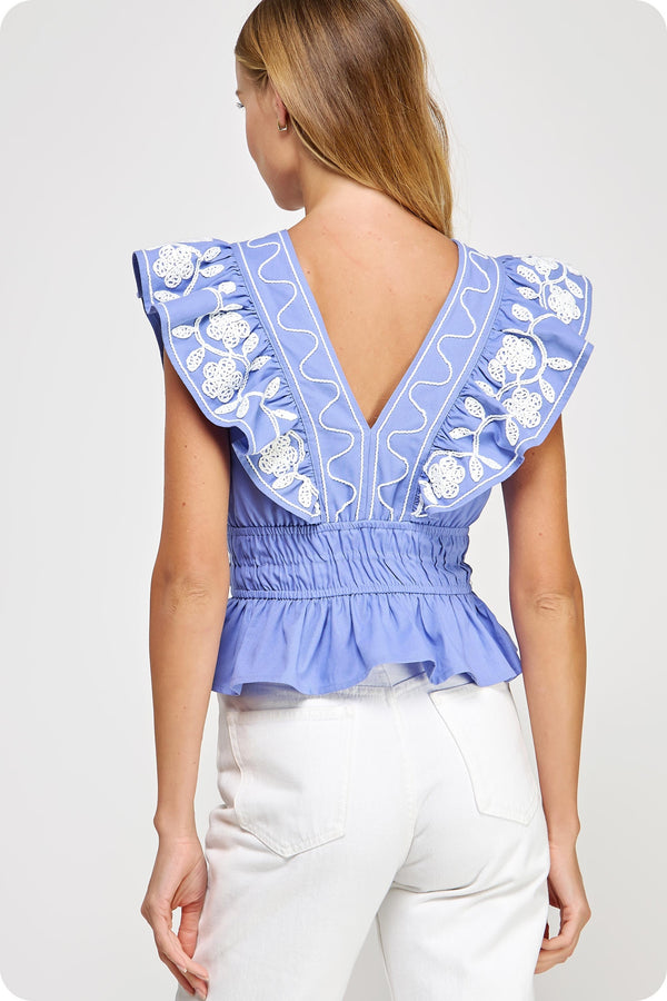 Women's boutique clothing: embroidered ruffle V-neck sleeveless top in blue, perfect for summer collection and resort wear.