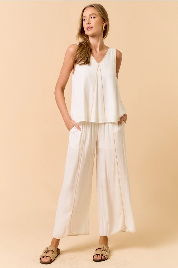 Off white sleeveless top with matching pants set, perfect for summer resort wear. Women's boutique clothing for new arrivals.