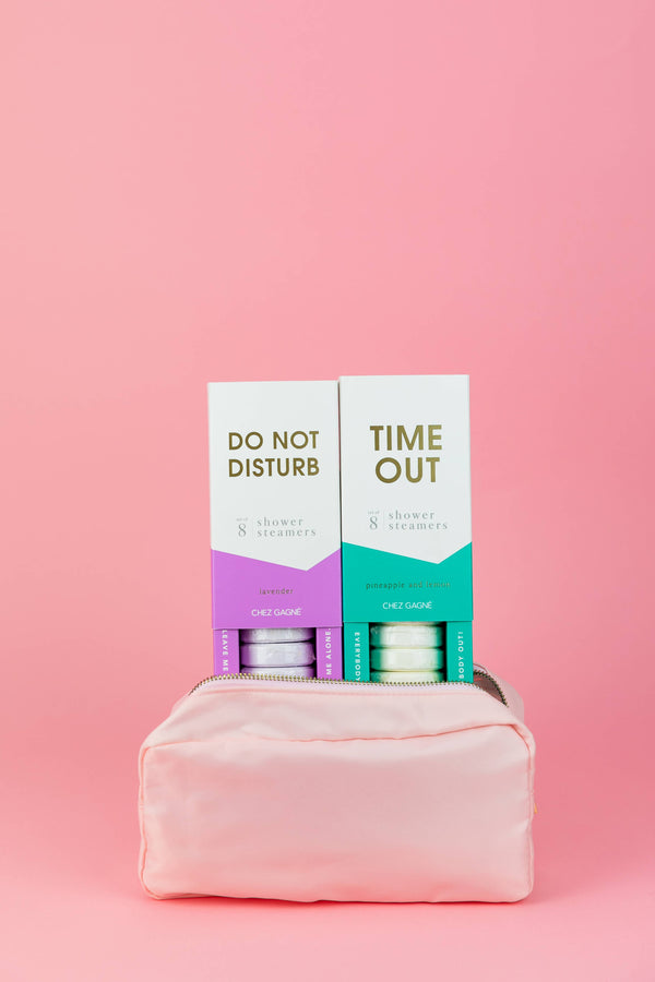 Time Out and Do Not Disturb shower steamers displayed with a pink cosmetic bag, perfect for exclusive women's fashion and summer collection.