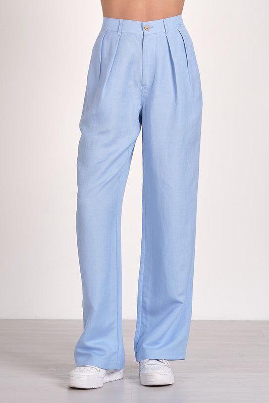 Light blue pleated pants with pockets, perfect for women's boutique clothing, summer collection, and new arrivals boutique.