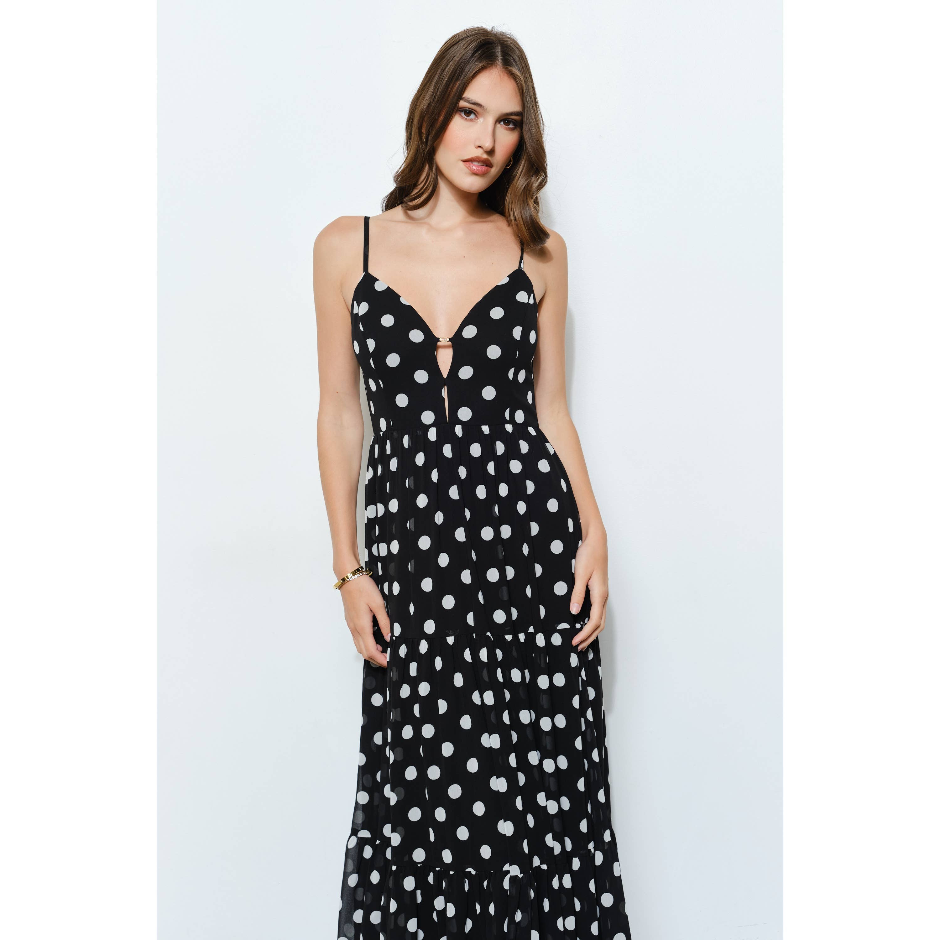 Gold polka dot maxi dress with front cutout and adjustable straps, perfect for summer brunches and resort wear.