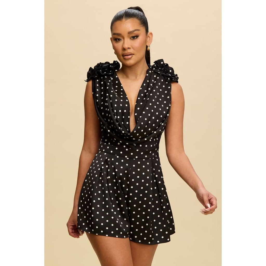 Elegant Black & White Polka Dot Cowl Romper from our women's boutique clothing, featuring floral appliqués and pleated shorts.
