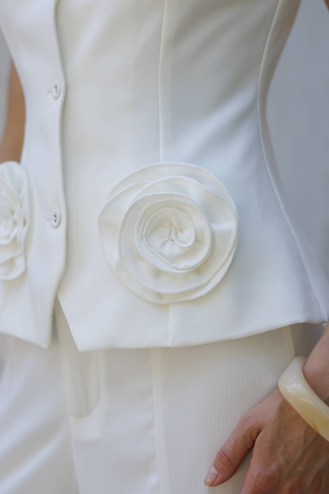 Women's boutique clothing: Rosette Peplum White Two-Pie Set with flower embellishments, perfect summer collection boutique outfit.