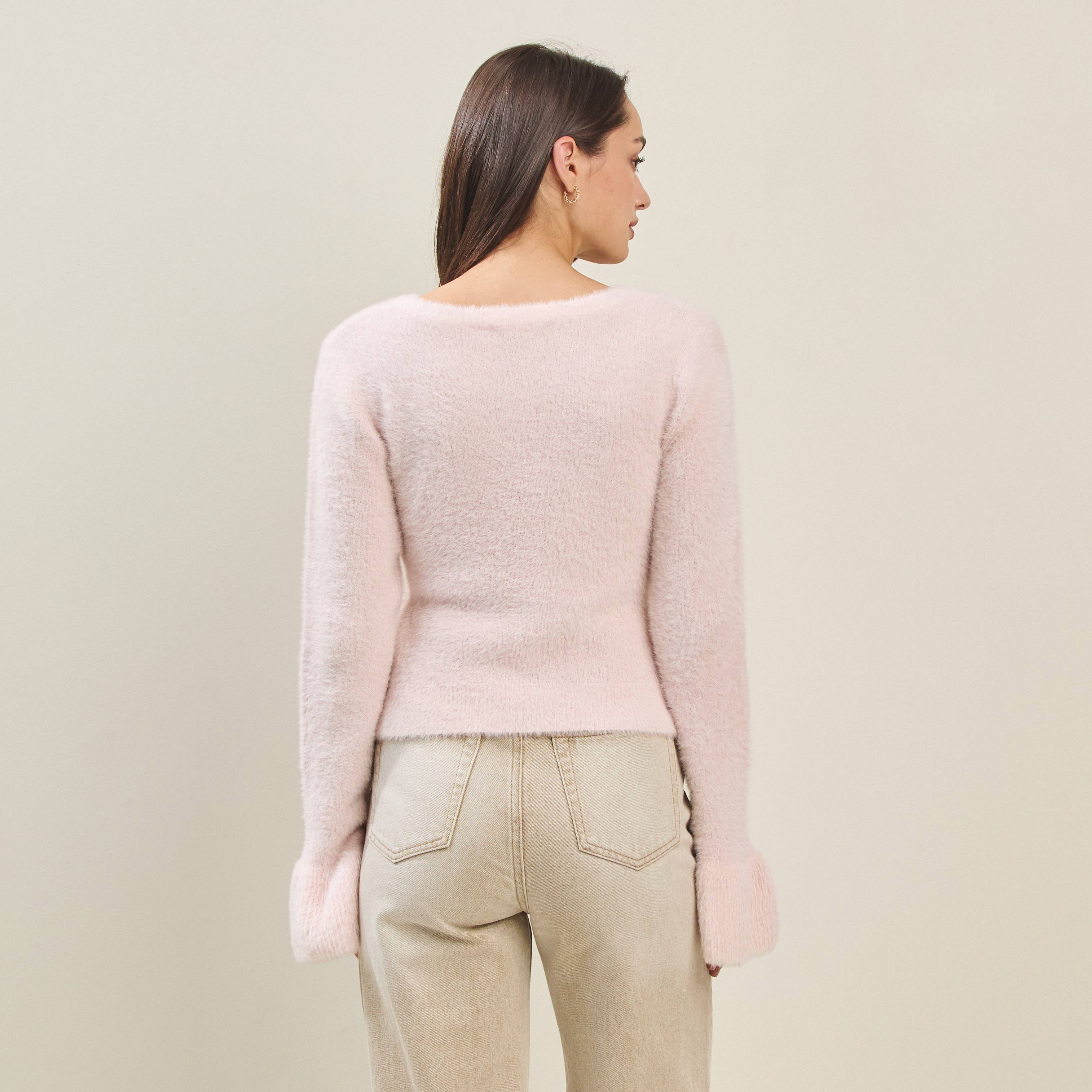 Back view of a women's fuzzy cardigan with bow buttons, perfect for summer collection boutique and new arrivals in women's fashion.