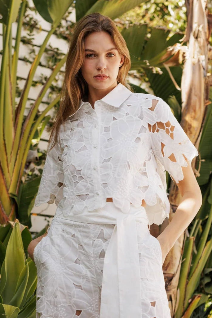 White short sleeve top with lace cutouts, perfect for summer collection boutique and exclusive women's fashion.