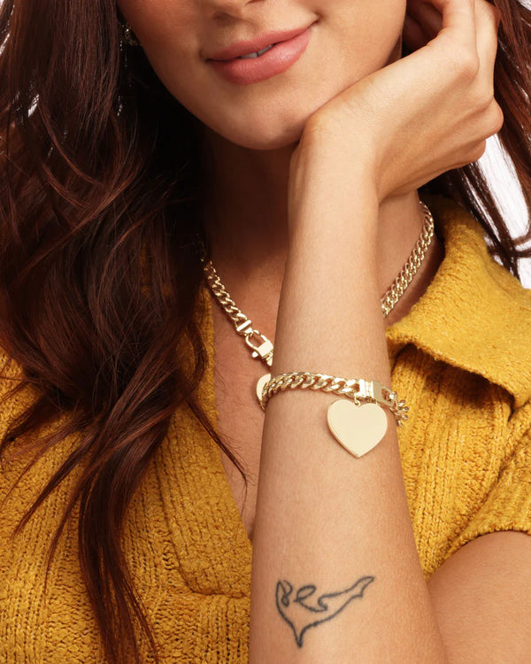 Model wearing Julian XL Heart Cuban Chain Bracelet, showcasing women's jewelry. Perfect for summer collection boutique style.