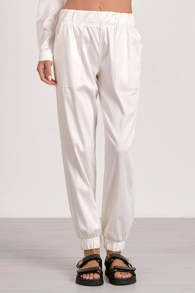 Iris white pants for women featuring pockets, elastic waist, and bottom hem. Perfect for summer collection boutique wear.