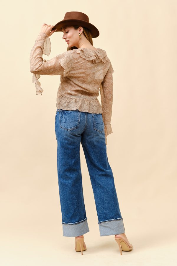 Women in a floral crinkle ruffle tie front top with denim jeans and a hat, showcasing exclusive women's fashion and boutique style.