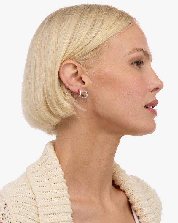 Profile of a model wearing the 'They're So Cute' Huggie Hoop Set, showcasing women's boutique jewelry designed for summer collection.