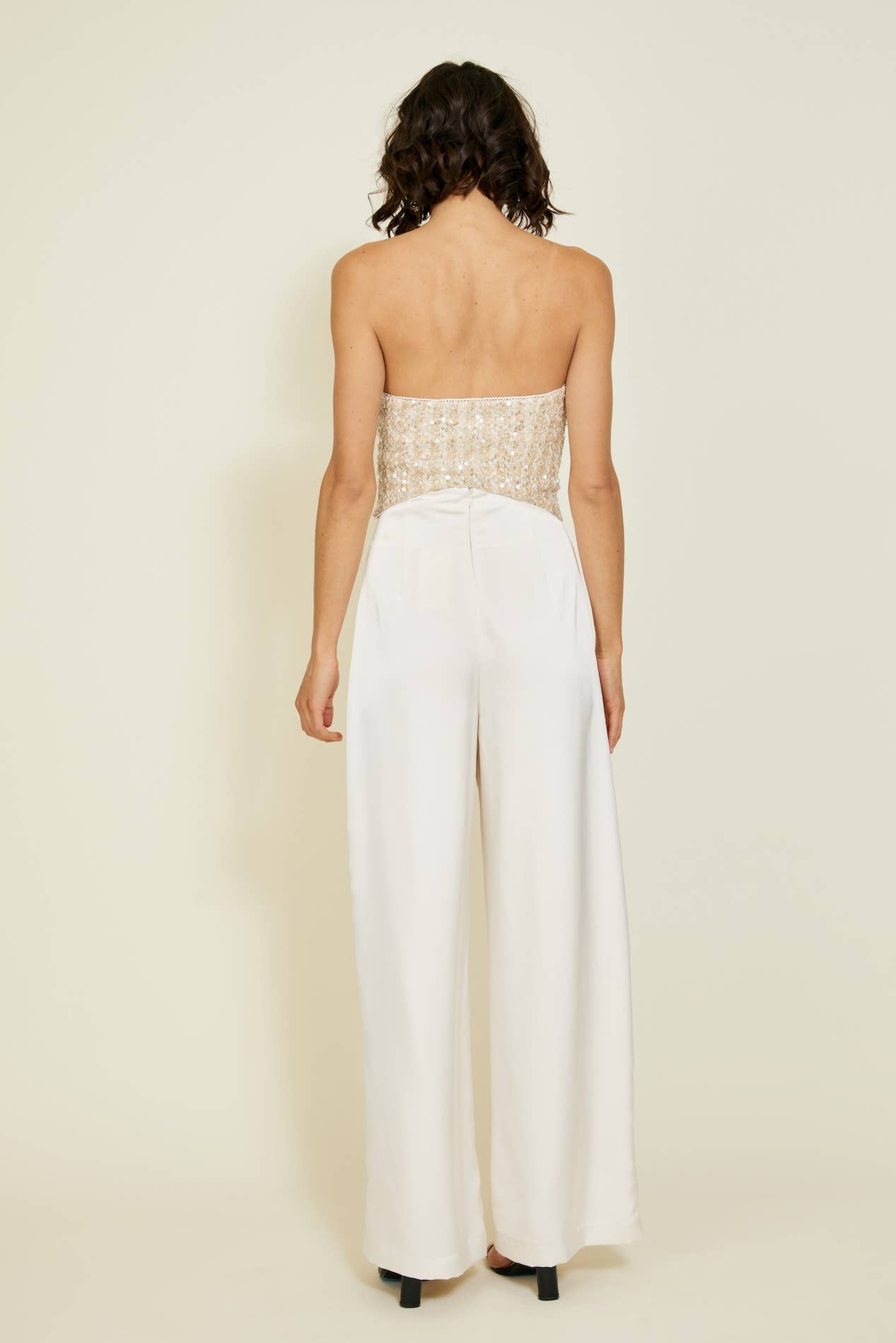 Back view of a women's strapless ivory jumpsuit with a beaded bodice, perfect for summer collection boutique and new arrivals.
