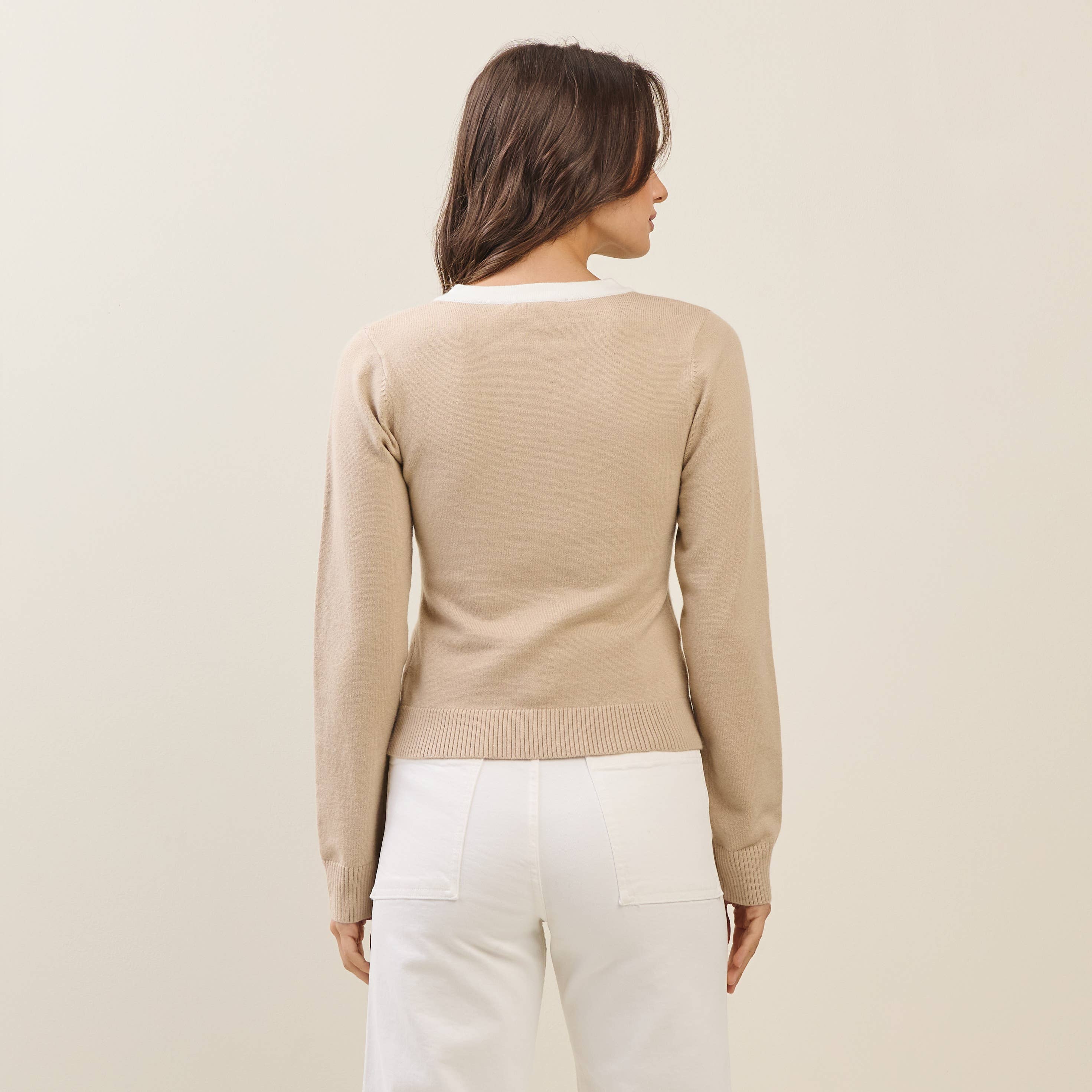 Back view of a model in a taupe and white long sleeve cardigan, showcasing exclusive women's fashion for boutique new arrivals.