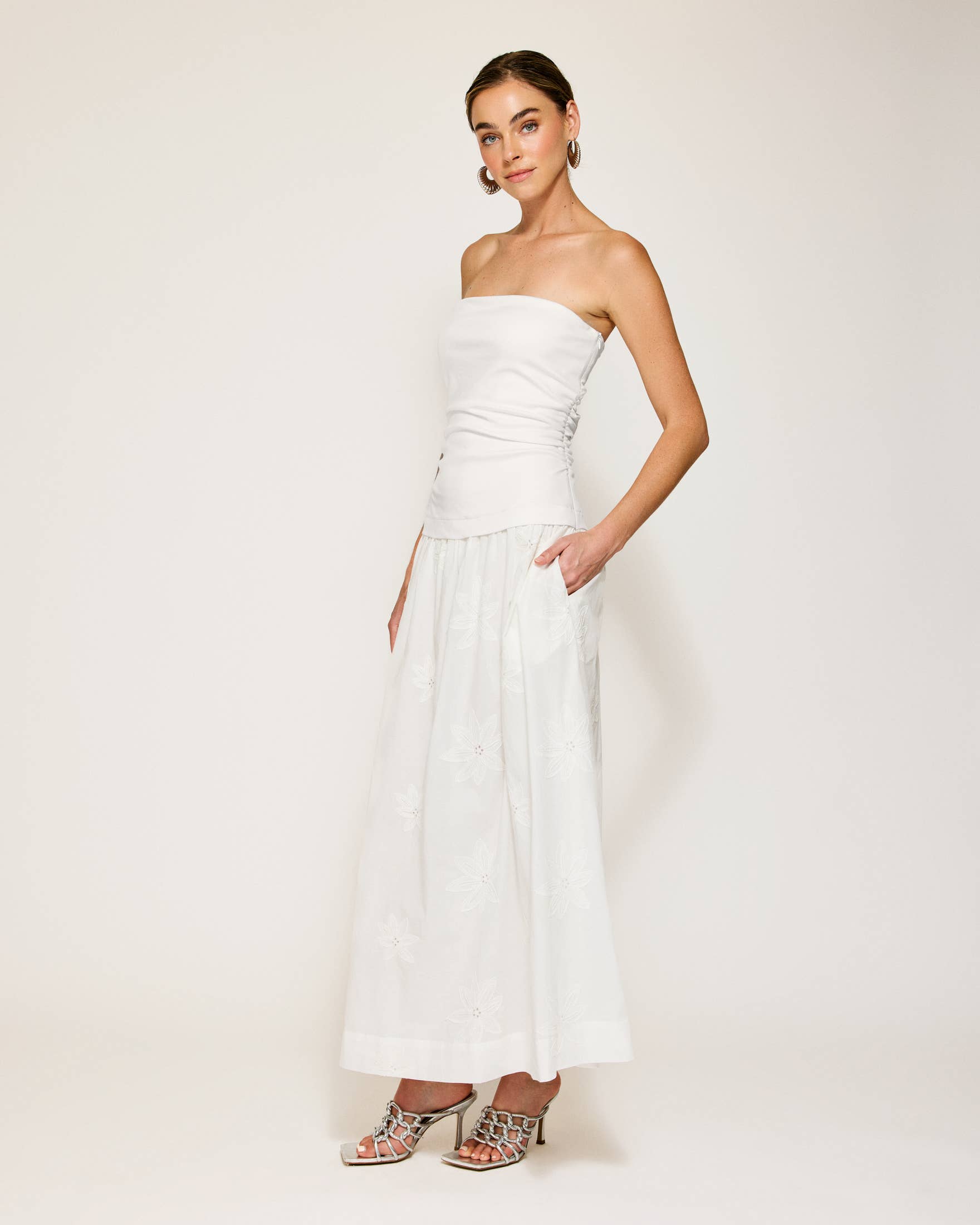 Emberly strapless white maxi dress, perfect for resort wear or summer collection boutique. Stylish and feminine design.