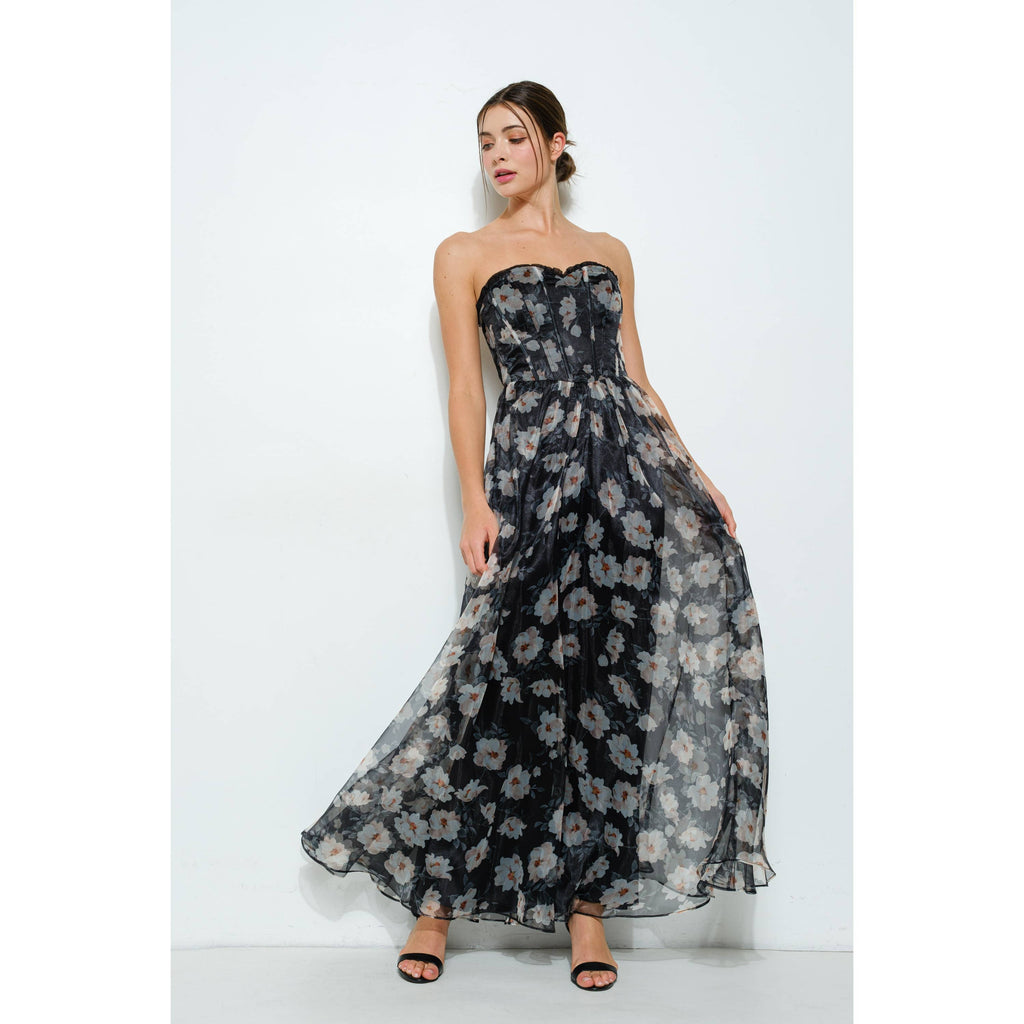 Elegant strapless taupe and black floral maxi dress with corset bodice. Perfect for summer resort wear and boutique collections.