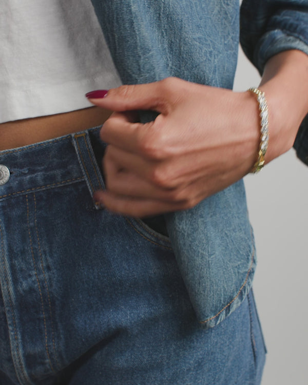 Model showcasing the Baby Julian Loves Diamonds Bracelet with denim outfit, a perfect accessory from exclusive women's fashion.
