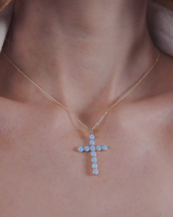 Women's jewelry featuring the 'Oh She Fancy' Blue Opal Cross Pendant, perfect for resort wear and exclusive fashion collections.