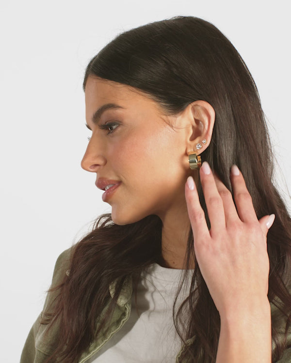 Stylish woman wearing .75" Atlas Hoops earrings, part of the exclusive women's fashion summer collection boutique.