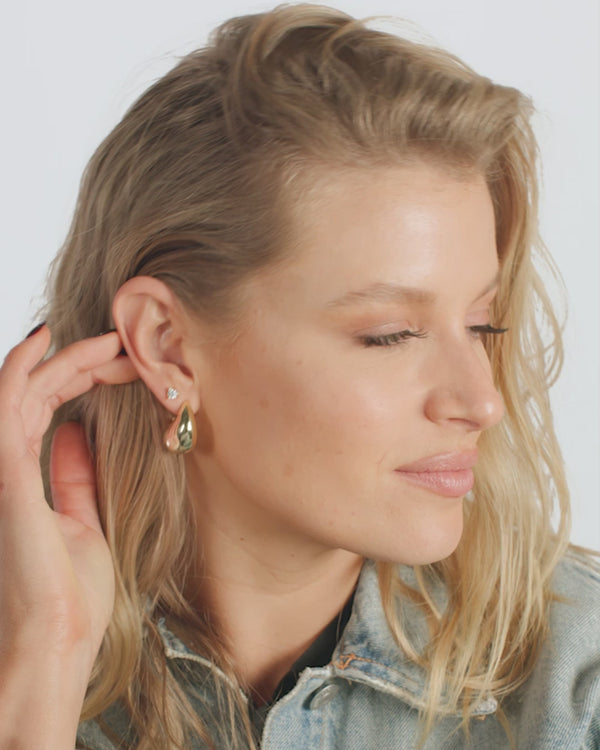Model showcasing She's So Smooth teardrop hoop earrings, perfect for summer collection boutique and new arrivals in women's jewelry.