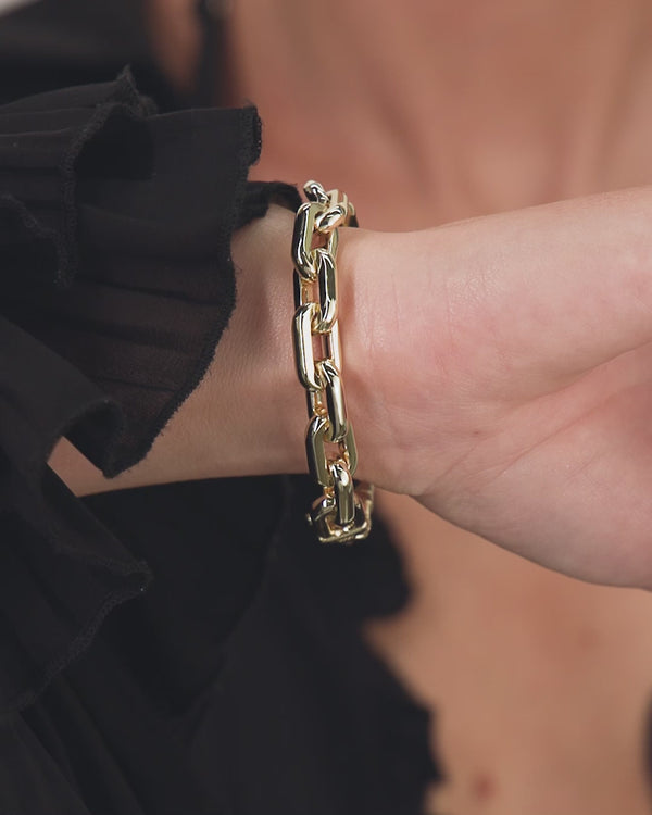Chunky gold Frankie Chain Bracelet worn on wrist, perfect for enhancing women's boutique clothing and summer collection styles.