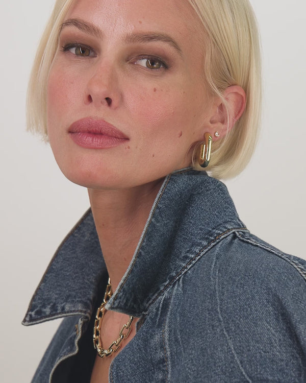 Model showcasing Frankie Chain Huggies earrings, paired with trendy denim jacket, part of women's boutique collection.