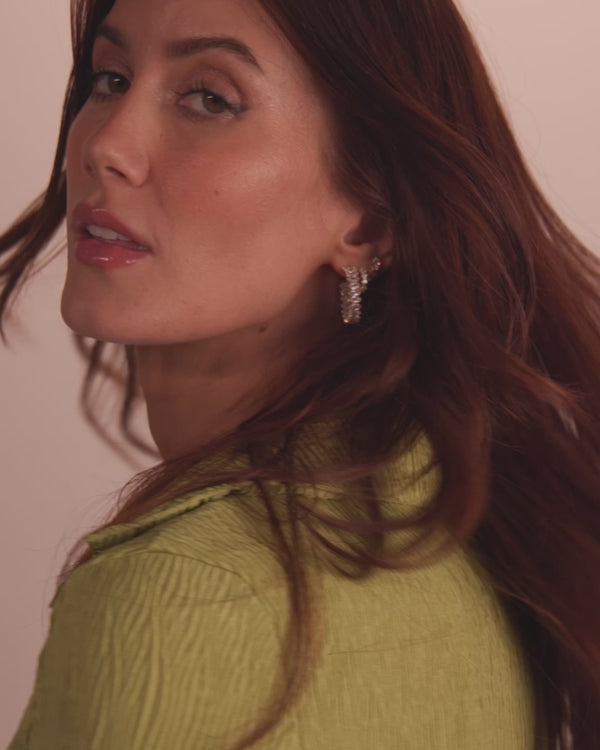 Model showcasing glamorous earrings, perfect addition to women's boutique clothing and exclusive women's fashion collections.